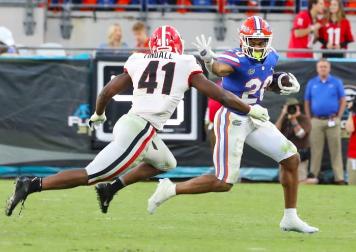 Florida running back Malik Davis (20) tries to avoid Georgia Bulldogs linebacker Channing Tindall (41). Brad McClenny/The Gainesville Sun / USA TODAY NETWORK